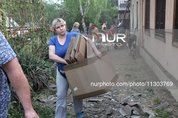 People are removing the debris following a nighttime Russian missile strike in Dnipro, Ukraine, on June 4, 2024. Ukraine's air defense force...