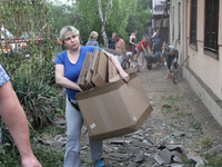 People are removing the debris following a nighttime Russian missile strike in Dnipro, Ukraine, on June 4, 2024. Ukraine's air defense force...