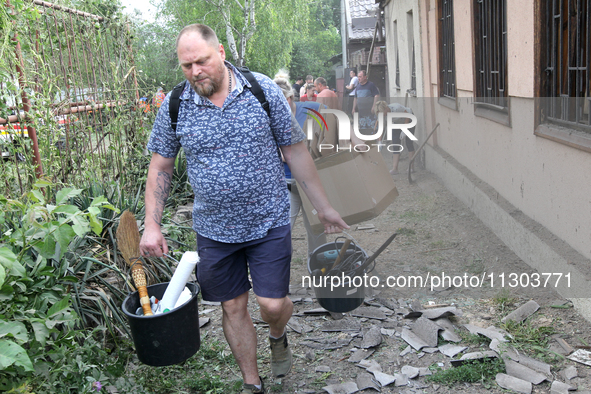 People are removing the debris following a nighttime Russian missile strike in Dnipro, Ukraine, on June 4, 2024. Ukraine's air defense force...