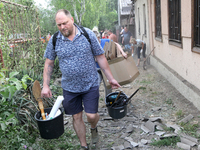 People are removing the debris following a nighttime Russian missile strike in Dnipro, Ukraine, on June 4, 2024. Ukraine's air defense force...