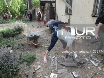 People are removing the debris following a nighttime Russian missile strike in Dnipro, Ukraine, on June 4, 2024. Ukraine's air defense force...