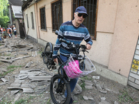 A man is carrying a salvaged bicycle following a nighttime Russian missile attack in Dnipro, Ukraine, on June 4, 2024. As reported by Ukrinf...