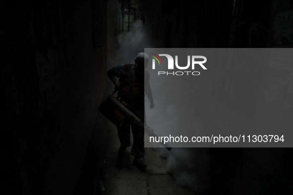 A municipal worker from the Department of Health Service is fumigating vapor to stem the spread of dengue in Dhaka, Bangladesh, on June 4, 2...