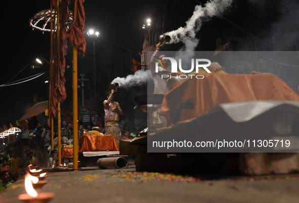 Hindu priests are worshipping during Ganga aarti on the ghats of the river Ganga in Varanasi, India, on June 2, 2024, after the day of Loksa...