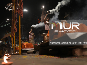 Hindu priests are worshipping during Ganga aarti on the ghats of the river Ganga in Varanasi, India, on June 2, 2024, after the day of Loksa...