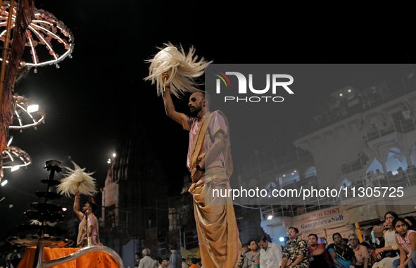 Hindu priests are worshipping during Ganga aarti on the ghats of the river Ganga in Varanasi, India, on June 2, 2024, after the day of Loksa...