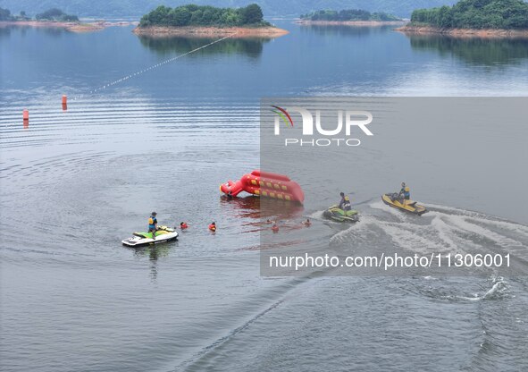 An emergency rescue drill for the 2024 Thousand Island Lake water sports leisure project is taking place in Hangzhou, China, on June 4, 2024...