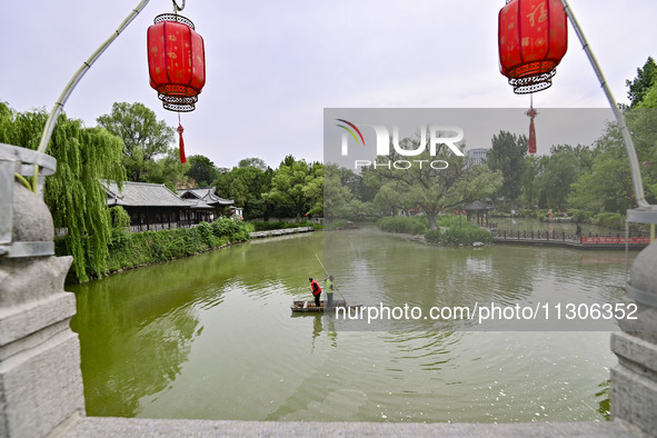 Volunteers are cleaning up floating objects on a river in Qingzhou, China, on June 5, 2024. 