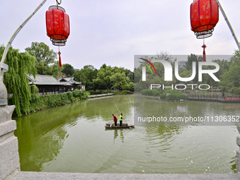 Volunteers are cleaning up floating objects on a river in Qingzhou, China, on June 5, 2024. (