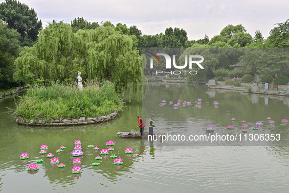 Volunteers are cleaning up floating objects on a river in Qingzhou, China, on June 5, 2024. 