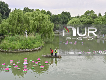 Volunteers are cleaning up floating objects on a river in Qingzhou, China, on June 5, 2024. (