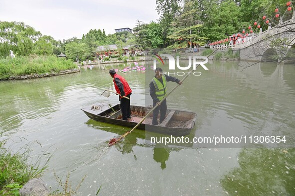 Volunteers are cleaning up floating objects on a river in Qingzhou, China, on June 5, 2024. 