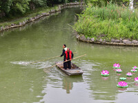 Volunteers are cleaning up floating objects on a river in Qingzhou, China, on June 5, 2024. (