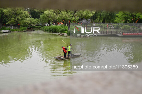 Volunteers are cleaning up floating objects on a river in Qingzhou, China, on June 5, 2024. 