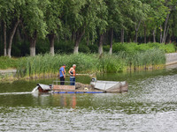 Volunteers are cleaning up floating objects on a river in Qingzhou, China, on June 5, 2024. (