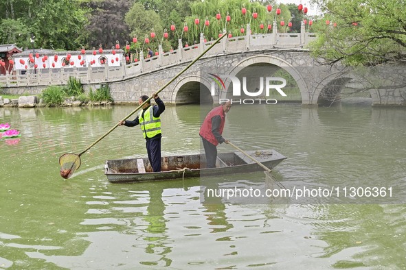 Volunteers are cleaning up floating objects on a river in Qingzhou, China, on June 5, 2024. 