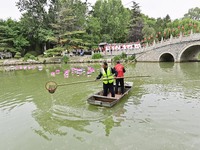 Volunteers are cleaning up floating objects on a river in Qingzhou, China, on June 5, 2024. (