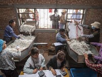 Silkworm farmers are selling silkworm cocoons at a silkworm cocoon buying point in Hai'an, China, on June 4, 2024. (