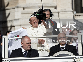 Pope Francis is waving as he is arriving to lead the weekly general audience in Saint Peter's Square, Vatican City, on June 5, 2024. (