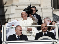 Pope Francis is waving as he is arriving to lead the weekly general audience in Saint Peter's Square, Vatican City, on June 5, 2024. (