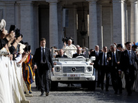 Pope Francis is waving as he is arriving to lead the weekly general audience in Saint Peter's Square, Vatican City, on June 5, 2024. (