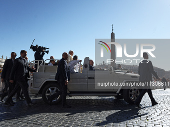 Pope Francis is waving as he is arriving to lead the weekly general audience in Saint Peter's Square, Vatican City, on June 5, 2024. (