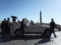 Pope Francis is waving as he is arriving to lead the weekly general audience in Saint Peter's Square, Vatican City, on June 5, 2024. (