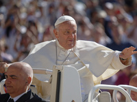 Pope Francis is waving as he is arriving to lead the weekly general audience in Saint Peter's Square, Vatican City, on June 5, 2024. (