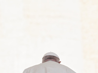 Pope Francis is being photographed from behind with the skullcap and white background during his weekly general audience in Saint Peter's Sq...