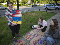 Anastasiia, a psychotherapist from Ukraine holds a cloth made of American and Ukrainian flags donated by friends from the US is seen during...