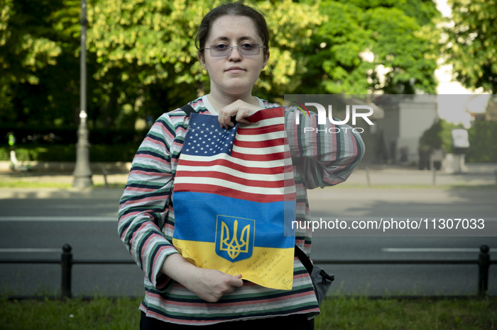 Anastasiia, a psychotherapist from Ukraine holds a cloth made of American and Ukrainian flags donated by friends from the US is seen during...