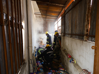 Nepali firefighters from the Armed Police Force, Nepal Army, and the Fire Brigade are dousing a fire that broke out in a warehouse in Kathma...