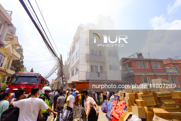 Smoke is billowing from a building that hosts the godown of a confectionery supplier in Kathmandu, Nepal, on June 5, 2024. Fire incidents ar...