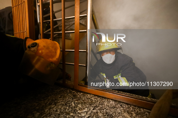 Nepali firefighters from the Armed Police Force, Nepal Army, and the Fire Brigade are dousing a fire that broke out in a warehouse in Kathma...