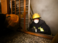 Nepali firefighters from the Armed Police Force, Nepal Army, and the Fire Brigade are dousing a fire that broke out in a warehouse in Kathma...