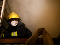 Nepali firefighters from the Armed Police Force, Nepal Army, and the Fire Brigade are dousing a fire that broke out in a warehouse in Kathma...