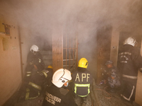 Nepali firefighters from the Armed Police Force, Nepal Army, and the Fire Brigade are dousing a fire that broke out in a warehouse in Kathma...