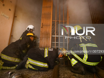 Nepali firefighters from the Armed Police Force, Nepal Army, and the Fire Brigade are dousing a fire that broke out in a warehouse in Kathma...