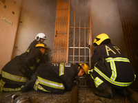 Nepali firefighters from the Armed Police Force, Nepal Army, and the Fire Brigade are dousing a fire that broke out in a warehouse in Kathma...