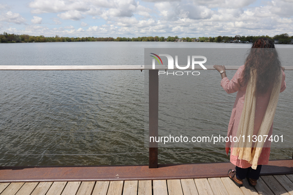 A woman is looking out towards Lake Wilcox in Richmond Hill, Ontario, Canada, on May 12, 2024. 