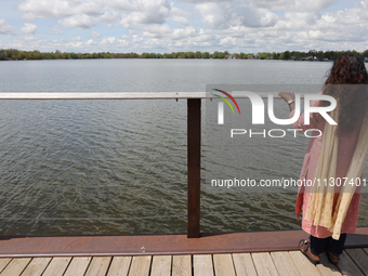 A woman is looking out towards Lake Wilcox in Richmond Hill, Ontario, Canada, on May 12, 2024. (