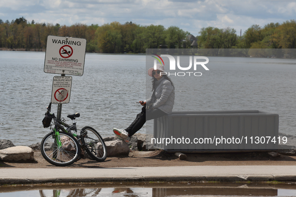 A woman is standing by Lake Wilcox in Richmond Hill, Ontario, Canada, on May 12, 2024. 