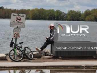 A woman is standing by Lake Wilcox in Richmond Hill, Ontario, Canada, on May 12, 2024. (