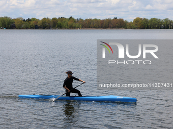 A man is paddling a small watercraft along Lake Wilcox in Richmond Hill, Ontario, Canada, on May 12, 2024. (