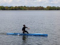 A man is paddling a small watercraft along Lake Wilcox in Richmond Hill, Ontario, Canada, on May 12, 2024. (