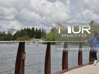 A woman is looking out towards Lake Wilcox in Richmond Hill, Ontario, Canada, on May 12, 2024. (