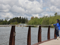 A woman is looking out towards Lake Wilcox in Richmond Hill, Ontario, Canada, on May 12, 2024. (