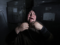 Palestinians are mourning relatives killed in Israeli bombardment of a house in al-Maghazi refugee camp, at the Al-Aqsa Martyrs Hospital in...