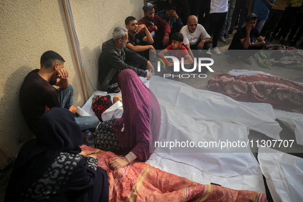 Palestinians are mourning relatives killed in Israeli bombardment of a house in al-Maghazi refugee camp, at the Al-Aqsa Martyrs Hospital in...