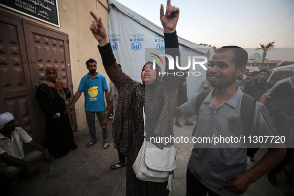 Palestinians are mourning relatives killed in Israeli bombardment of a house in al-Maghazi refugee camp, at the Al-Aqsa Martyrs Hospital in...